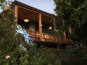 a house with a porch with lights on it at Hotel 381 Panguipulli in Panguipulli
