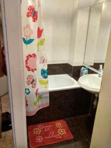 a bathroom with a shower curtain and a sink at Martin`s apartments in Stara Zagora +38 photos