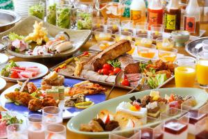 a table with many plates of food and drinks at Hotel Kyocera in Kirishima