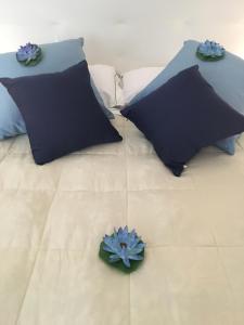 a bed with two pillows on it with two blue at vernazza vacation 3 in Vernazza