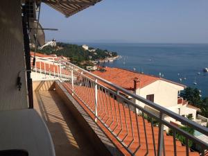 a balcony of a building with a view of the ocean at Nela Apartment in Rabac