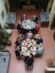 a group of people sitting at a table eating food at dar wassim el ghali in Rabat