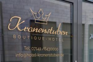a sign for a hotel with a crown on a window at Boutique-Hotel Kronenstuben in Ludwigsburg +126 photos