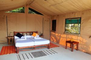 a bedroom with a bed in a tent at Back of Beyond Dune Camp Yala in Yala