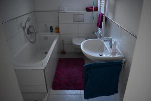 La salle de bains est pourvue d'un lavabo, d'une baignoire et de toilettes. dans l'établissement Im Herzen von Kernen, à Kernen