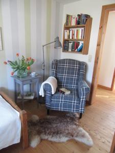 a living room with a chair and a lamp at EIFEL Gästewohnung in Blankenheim
