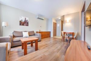 a living room with a couch and a table at Apartament Sun & Snow Gwiazda Morza in Władysławowo