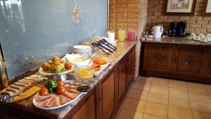 a kitchen with a buffet of food on a counter at Bokmakierie Country Lodge in Ladysmith