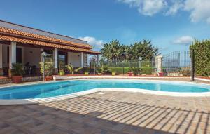 a swimming pool in front of a house at Villa Sunshine in Balestrate