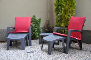 a couple of chairs and a table with red cushions at M48 apartments in Belgrade