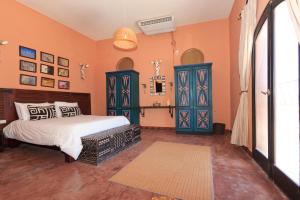 a bedroom with a bed and some blue cabinets at Blue Beach Club Apartment in Dahab