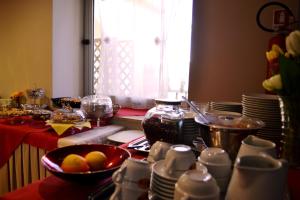 a kitchen with a table with plates and fruit in a bowl at Hotel San Martino in Cassibile