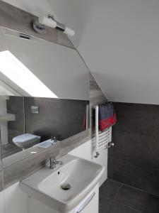 a bathroom with a sink and a mirror at Villa Anna in Międzywodzie +35 photos