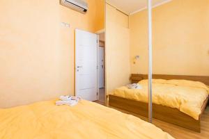 a bedroom with two beds and a mirror at Bomboniera fronte mare ! in Viareggio