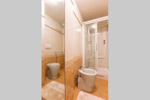 a bathroom with a toilet and a shower and a bidet at Bomboniera fronte mare ! in Viareggio +9 photos