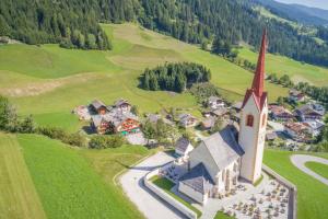 an aerial view of a small village with a church at Hotel Tolderhof in San Candido
