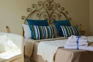 a bed with blue and white pillows on it at Casa Emilia in Sorrento
