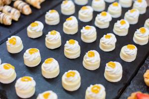 a tray filled with whipped cream and orange slices at Hipotels Barrosa Garden in Chiclana de la Frontera