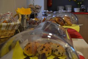 a table with a plate of cookies and pastries at Hotel San Martino in Cassibile