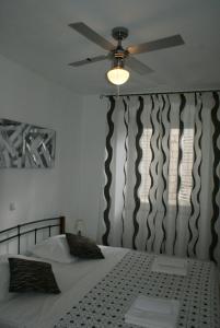 a bedroom with a bed with a ceiling fan at Apartman Old Town in Trogir
