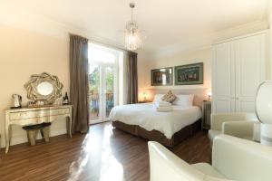 a bedroom with a bed and a window and a couch at Westwood Guest House - Room Only in Lyme Regis