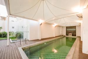 an indoor swimming pool with a large tent at SRS Springs Hotels and Spa in Bangalore