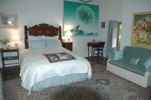 a bedroom with a large bed and a couch at Mid Wales Arts B&B in Caersws