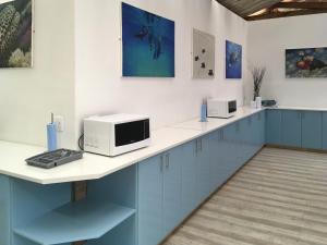 a kitchen with a counter with two microwaves on it at Coral Divers in Sodwana Bay