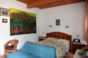 una camera da letto con un letto e un dipinto sul muro di Don Raffaele a Lecce