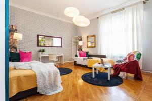 a bedroom with two beds and a living room at Designer Apartment Eclectica in Belgrade