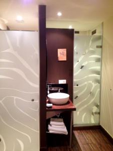 a bathroom with a sink and a mirror at Pensión Basic Confort in San Sebastián