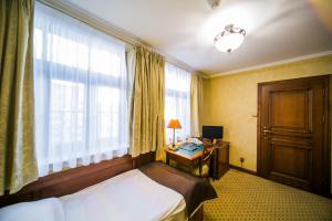 Postel nebo postele na pokoji v ubytování Hotel Opera