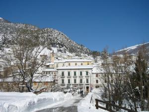 a snow covered city with a building in the background at Il rifugio nel parco in Villetta Barrea