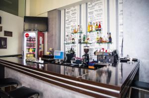a bar in a restaurant with a counter and a refrigerator at Hotel Seven in Cluj-Napoca