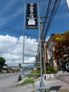 a sign on the side of a street at Giorgio's Place in Polomolok