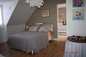 a bedroom with a bed and a table in it at Les Tilleuls in Ballan-Miré