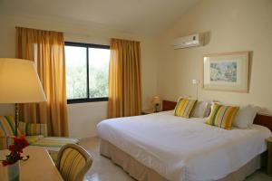 a hotel room with a bed and a window at Club Aphrodite in Erimi