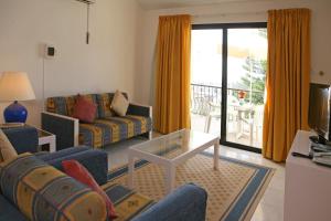 a living room with a couch and a table at Club Aphrodite in Erimi