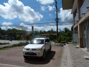 a white car parked on the side of a street at Giorgio's Place in Polomolok