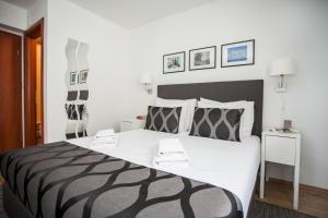 a bedroom with a large bed with two stools on it at Villa Ivanka in Trogir