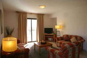 a living room with a couch and a table at Club Aphrodite in Erimi