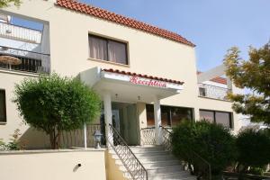 a white building with a sign on it at Club Aphrodite in Erimi