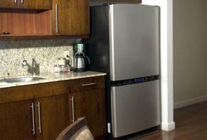 a kitchen with a refrigerator and a sink at The Fritz Hotel in Miami Beach