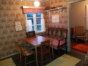 a dining room with a table and chairs and a window at Stuga på landet in Gunnarskog