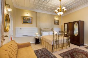 a bedroom with a bed and a couch at Darussaade Hotel Old City - Sultanahmet in Istanbul
