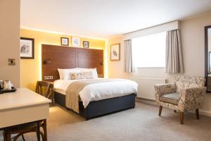 a bedroom with a bed and a desk and a chair at The Snowy Owl by Innkeeper's Collection in Cramlington