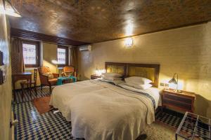 a bedroom with a large bed in a room at Riad Dar Cordoba in Fès