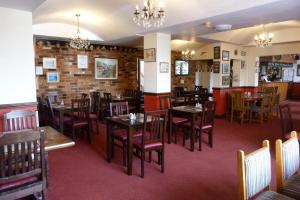 a dining room with tables and chairs in a restaurant at Railway Inn in Culham