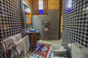 a bathroom with a toilet and a sink at Riad Dar Cordoba in Fès