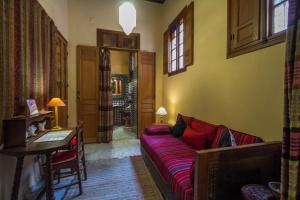 a living room with a couch and a table at Riad Dar Cordoba in Fès